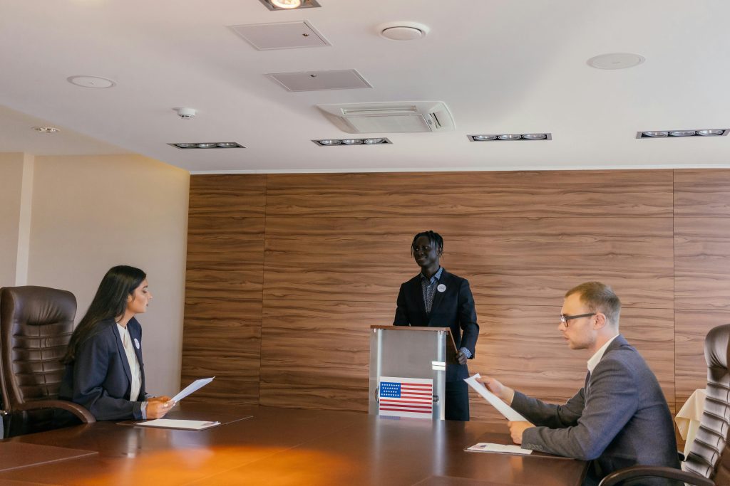 Business professionals engaged in a formal meeting, discussing key topics around a conference table.